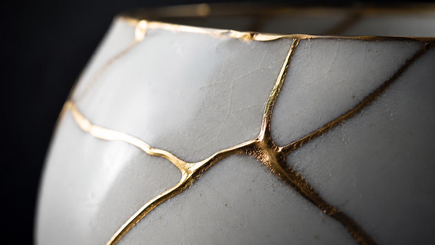 Kintsugi porcelain bowl rebuilt with seams of gold — restored more beautiful than before